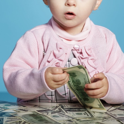 A baby playing with money