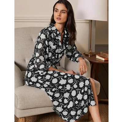 lady wearing Abigail midi shirtdress sits on coach