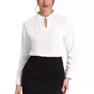 A woman wearing a white blouse and black pants