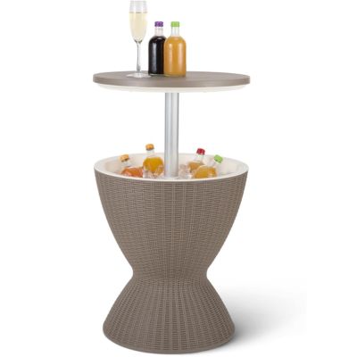 A bar table with the lower portion holding ice and bottled drinks and the tabletop holding two bottled drinks and a full wine glass