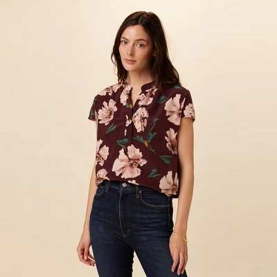 A lady weraring a “moody florals" top