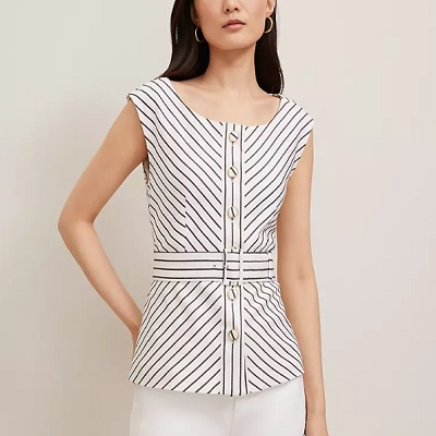 A woman wearing a white striped vest and white pants