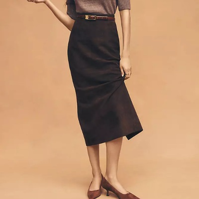 A woman wearing dark brown suede seamed pencil skirt