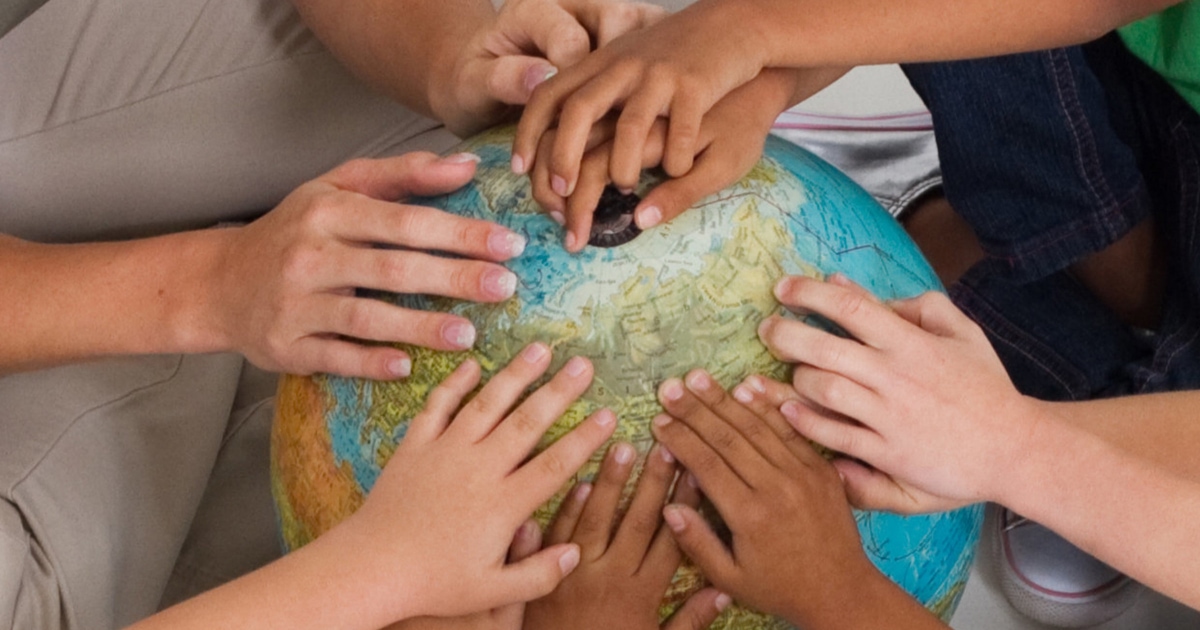 Children holding a globe