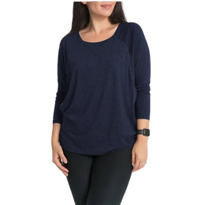 A woman wearing a navy nursing/maternity top and black pants