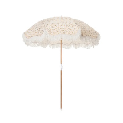 A white beach umbrella with an eyelet design