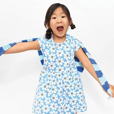 A girl wearing a blue Backyard Dress in Bold Blooms dress in floral print