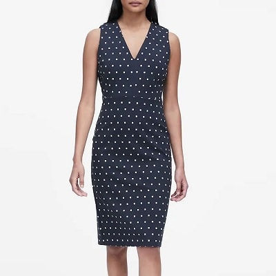 A woman wearing a Polka Dot Ponte Sheath Dress