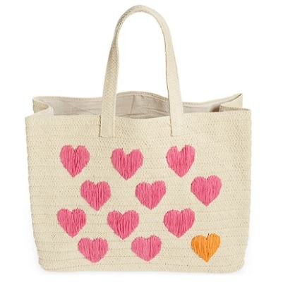 An off-white straw tote with pink and yellow hearts