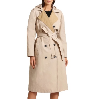 A woman wearing a khaki-colored trench coat