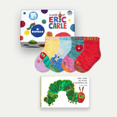 A set of colorful pair of Eric Carle toddler socks next to The Very Hungry Caterpillar book and a gift box