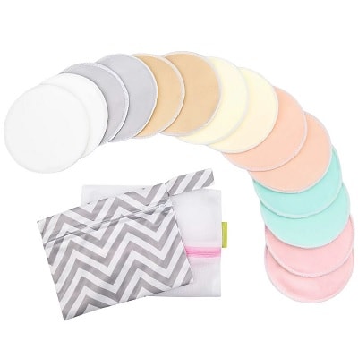 14 pastel reusable nursing pads next to a white storage bag and chevron-print storage bag
