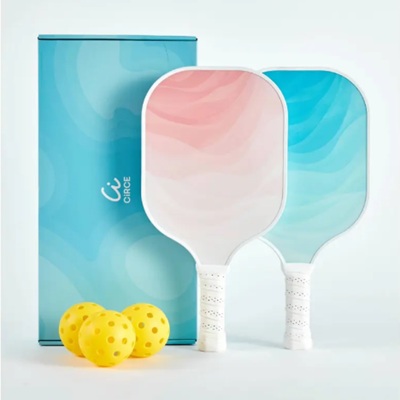 A pickleball set with yellow balls, a pink racket, a blue racket, and a blue storage box