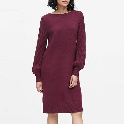 A woman wearing a maroon Cable-Knit Sweater Dress