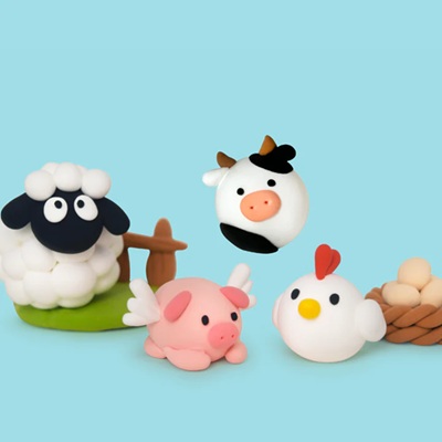 Five clay figures: a sheep, pig, cow, chicken, and nest with eggs