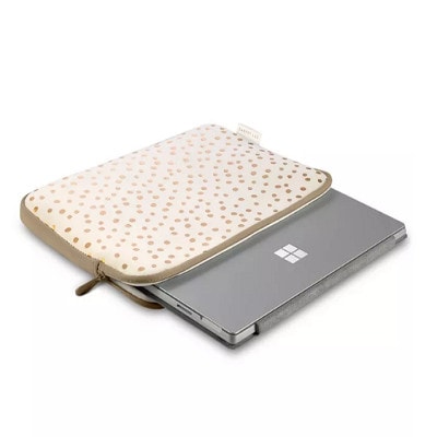 A cream-colored laptop sleeve with gold polka dots, with a laptop inside