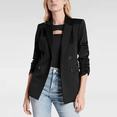 A lady wearing a black breasted blazer