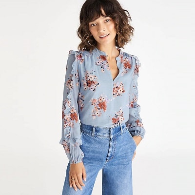 A woman wearing a Floral Ruffle-Sleeve Blouse