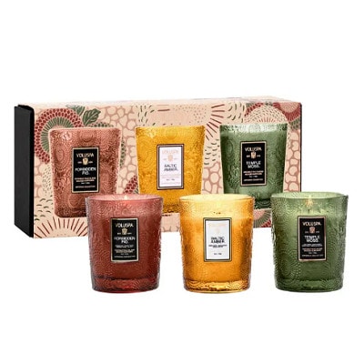 Three (red, yellow, and green) candles in front of the package