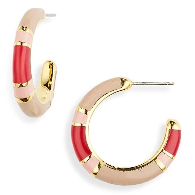 A pair of hoop earrings with a colorful resin design that includes pink, red, beige, and gold