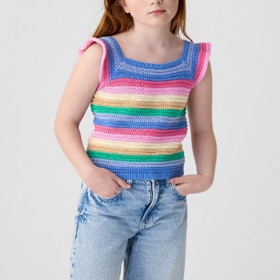 A girl wearing a multicolored crochet sleeveless top and blue jeans