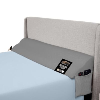A gray wedge pillow on a bed