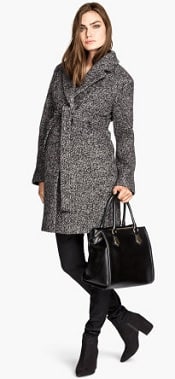 A woman wearing an HM Mama Wool Boucle Coat