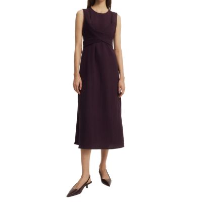 A woman wearing a black midi nursing dress and slingbacks
