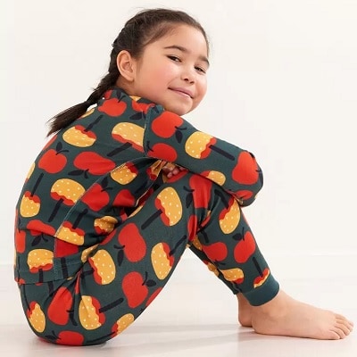 A girl wearing pajamas with a candy apples print
