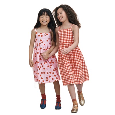Two young girls wearing a  pink strawberry-print dress and a red gingham dress