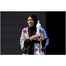 U.S. Olympic fencer Ibtihaj Muhammad holding the first hijab-wearing Barbie doll