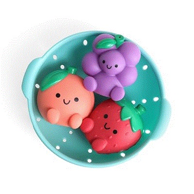 3 bath squirter toys in grape, strawberry, and peach shapes, sitting in a blue strainer bowl