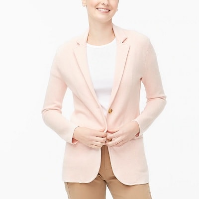 A woman wearing a pastel pink Sweater Blazer