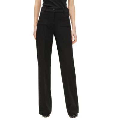 A woman wearing a black top, black pants, and black heels (torso cropped out)