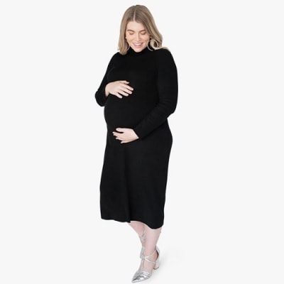 A pregnant lady wearing a black maternity dress