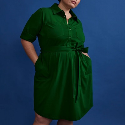 A woman wearing a dark green shirtdress