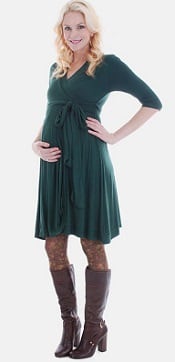 A woman in a forest green Kaitlyn Maternity Wrap Dress