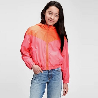 A young woman wearing a 100% Recycled Polyester Colorblock Windbuster