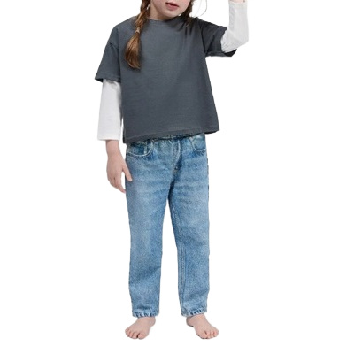A girl wearing jeans, a white turtleneck, and a gray tee