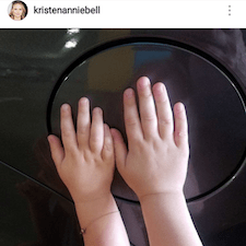 A baby hands on top of a glass table