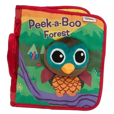 A soft book for babies with a cover that has an owl on a branch, a butterfly, a few flowers, with two mountains in the distance