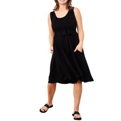A woman wearing a black nursing romper that looks like a dress