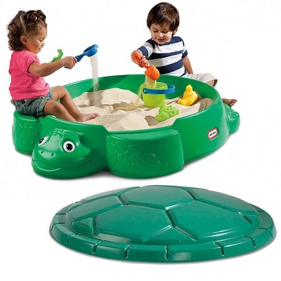 A children playing with Little Tikes Turtle Sandbox
