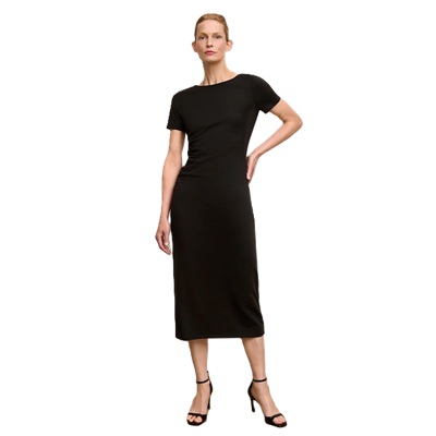 A woman wearing a black short-sleeve dress with black heels