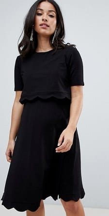 A woman wearing a Scallop Dress with Short Sleeves