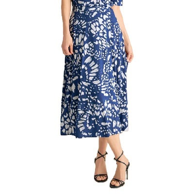 A woman wearing a blue-and-white print midi skirt and black strappy heels