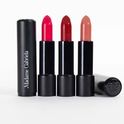 Five lipsticks, four standing up and one sideways; one open