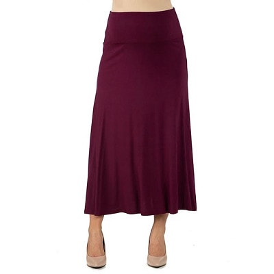 A woman wearing a burgundy maxi skirt and nude pumps