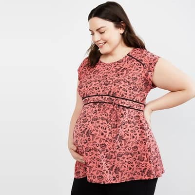 A woman wearing a Peplum Maternity Top