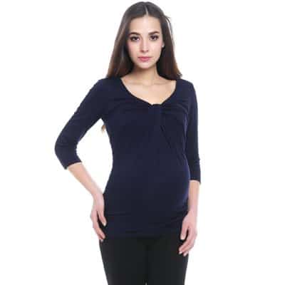 A woman wearing a \"Grace\" Twist Knot Maternity Top